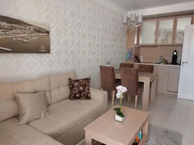 a living room with a couch and a table at HARMONY SUITES Grand Resort PREMIUM Ferienwohnung in Sunny Beach