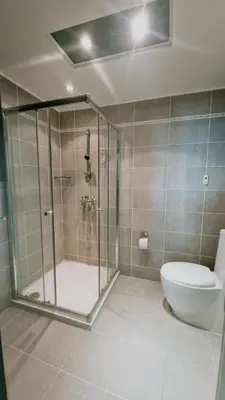 a bathroom with a shower and a toilet at Апартаменти Бяла Бийч - Apartments Byala Beach in Byala