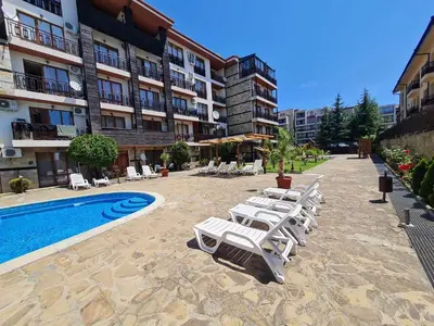 a row of lounge chairs next to a swimming pool at MitProt Panorama Bay 2 Studio 154 in Sveti Vlas