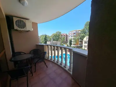 a balcony with a table and chairs and a view at Kalia Sunny Beach 1 bedroom apartment in Sunny Beach
