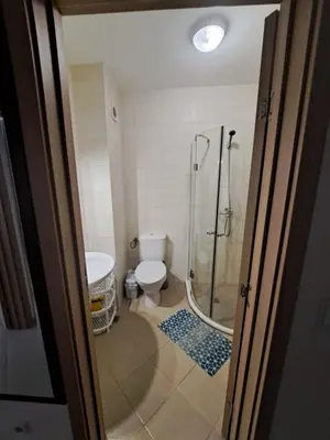 a bathroom with a shower and a toilet and a sink at Kalia Sunny Beach 1 bedroom apartment in Sunny Beach
