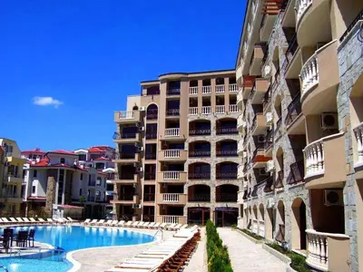 a large apartment building with a swimming pool next to a building at Kalia Sunny Beach 1 bedroom apartment in Sunny Beach