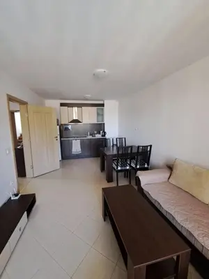 a living room with a couch and a table at Kalia Sunny Beach 1 bedroom apartment in Sunny Beach