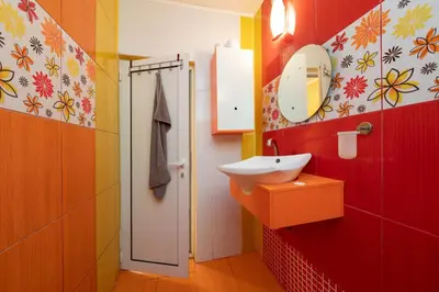 a bathroom with a sink and a mirror at Boris Garden Comfort Suite in Burgas City