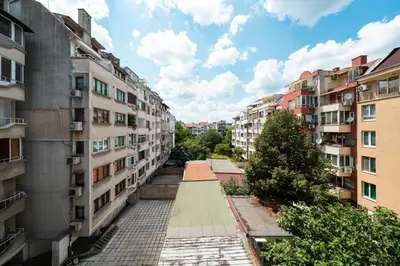 an empty alley between buildings in a city at Boris Garden Comfort Suite in Burgas City