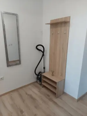 a room with a mirror and a desk and a vacuum at Апартамент 