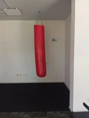 a red punching bag hanging on a wall at MIDIA Family Resort - studio s výhledem na moře in Aheloy