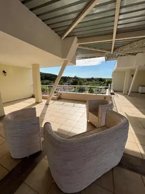 a patio with a couch and chairs on a building at Sunny house in Pismenovo