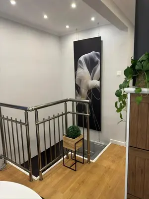 a staircase with a painting on the wall and a plant at Casa Raffaelo in Burgas City