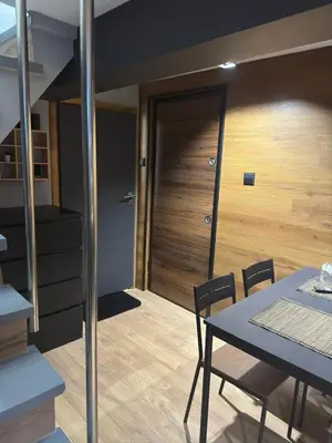 a dining room with a table and a door at Casa Raffaelo in Burgas City