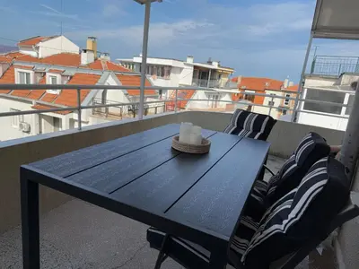 a black table on a balcony with a candle on it at KudevApartment1 in Nesebar