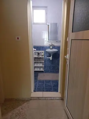 a bathroom with a sink and a toilet and a window at Guest House Dani in Pomorie