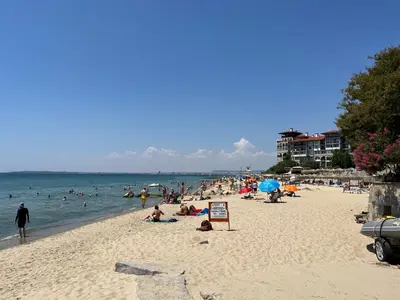 a group of people on a beach in the water at Apartament Studio Bułgaria Garden Of Eden in Sveti Vlas