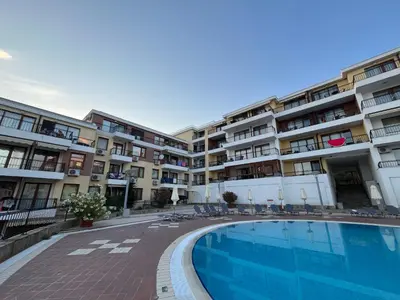 a hotel with a swimming pool in front of a building at Apartament Studio Bułgaria Garden Of Eden in Sveti Vlas