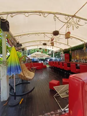 a restaurant with red chairs and an umbrella at Admiral Plaza 35 -studio-Sunny Beach in Sunny Beach