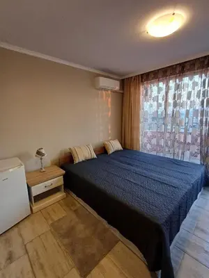 a bedroom with a large bed with a blue blanket at Admiral Plaza 35 -studio-Sunny Beach in Sunny Beach
