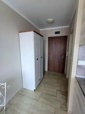 a hallway with a white cabinet and a door at Admiral Plaza 35 -studio-Sunny Beach in Sunny Beach