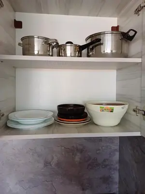a kitchen with plates and pots and pans on shelves at Admiral Plaza 35 -studio-Sunny Beach in Sunny Beach