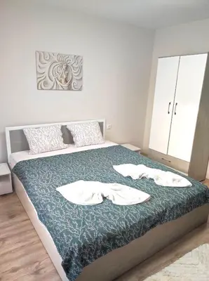 a bedroom with a bed with two towels on it at VN Home 2 in Pomorie