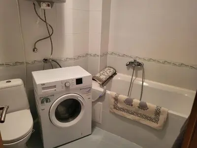 a bathroom with a washing machine and a toilet at Vineyard luxery spa resort in Kableshkovo