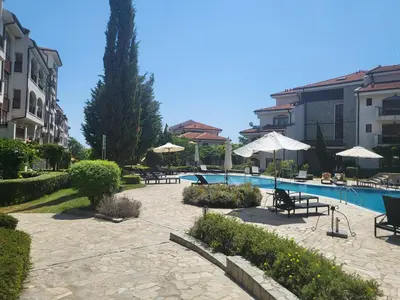 a resort with a pool and chairs and umbrellas at Vineyard luxery spa resort in Kableshkovo