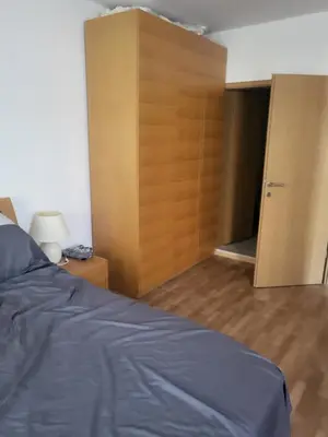 a bedroom with a bed and a closet and a door at Vineyard luxery spa resort in Kableshkovo