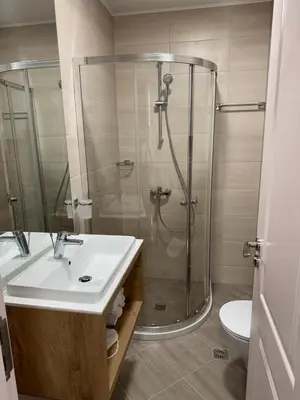 a bathroom with a shower and a sink and a toilet at Harmony Grand Resort - Apartament Gut in Sunny Beach