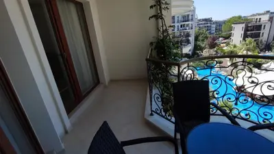 a balcony with chairs and a view of a city at Luxuriöse Ferienwohnung im Harmony Suites Monte Carlo in Sunny Beach