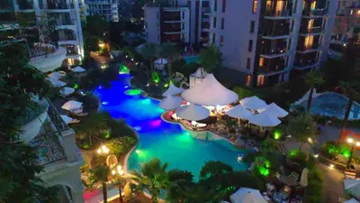 an aerial view of a swimming pool at night at Luxuriöse Ferienwohnung im Harmony Suites Monte Carlo in Sunny Beach