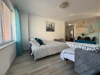a bedroom with a bed and a couch in it at BW - Aquamarin C6 in Sunny Beach