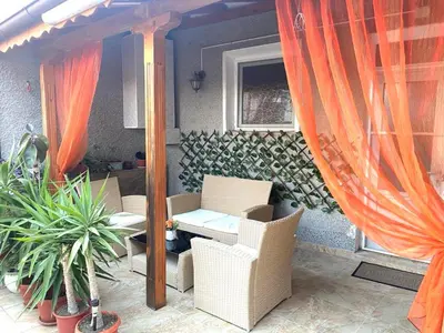a patio with chairs and a table and a window at VN Home 1 in Pomorie