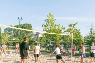 a group of people playing volley ball on a beach at Cascadas Family Resort apartment pool view in Sunny Beach