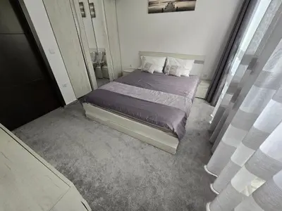 a small bedroom with a bed with purple sheets and pillows at Cascadas Family Resort apartment pool view in Sunny Beach