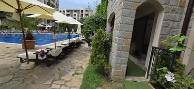 a row of tables and umbrellas next to a pool at Cascadas Family Resort apartment pool view in Sunny Beach