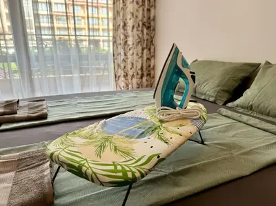 a bed with a foot board on top of it at Прекрасно място за нощувки в Слънчев бряг in Sunny Beach