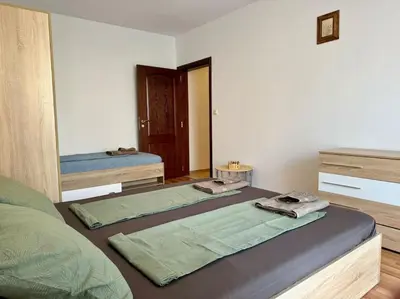 a bedroom with two beds and a mirror at Прекрасно място за нощувки в Слънчев бряг in Sunny Beach