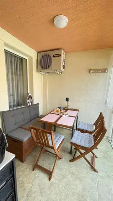 a living room with a couch and a table and chairs at Luxus und Komfort im Vista Residence Komplex in Sveti Vlas
