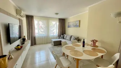 a living room with a table and a couch at Luxus und Komfort im Vista Residence Komplex in Sveti Vlas