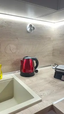 a red tea kettle sitting on top of a kitchen counter at Luxus und Komfort im Vista Residence Komplex in Sveti Vlas