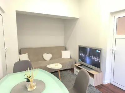 a living room with a couch and a tv at Apartment Compass- Super Center Burgas in Burgas City
