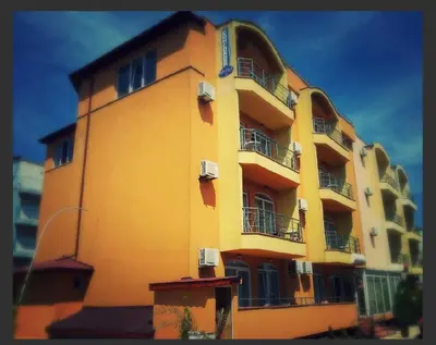 a yellow building with balconies on the side of it at Concordia Plaza 2 in Primorsko