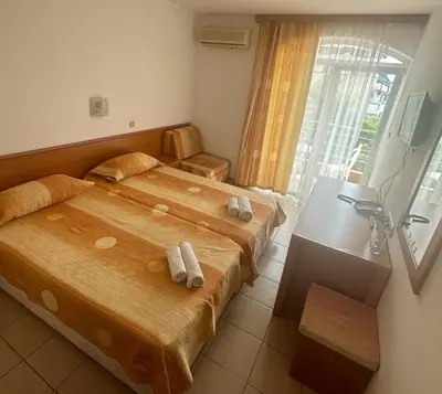 a hotel room with two beds with towels on them at Concordia Plaza 2 in Primorsko