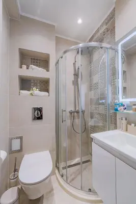 a bathroom with a shower and a toilet and a sink at Luxury Seaside Apartment in Varna City
