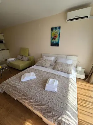 a bedroom with a large bed and a couch at Privet apartament in Premier Fort in Sveti Vlas