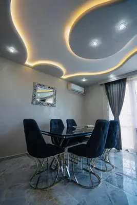 a dining room with a table and chairs at AR Luxury VIP Apartments Ravda in Ravda