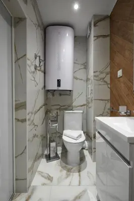a bathroom with a white toilet and a sink at Sea Sunrise Apartment Sozopol in Sozopol