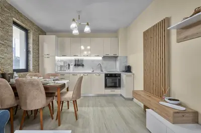 a kitchen and dining room with a table and chairs at Sea Sunrise Apartment Sozopol in Sozopol
