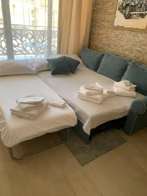two beds in a room with towels on them at Sea Sunrise Apartment Sozopol in Sozopol
