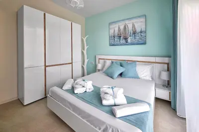 a bedroom with a bed with towels on it at Sea Sunrise Apartment Sozopol in Sozopol