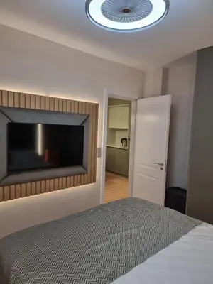 a bedroom with a bed with a large flat screen tv at Harmony Suites 16 in Sunny Beach